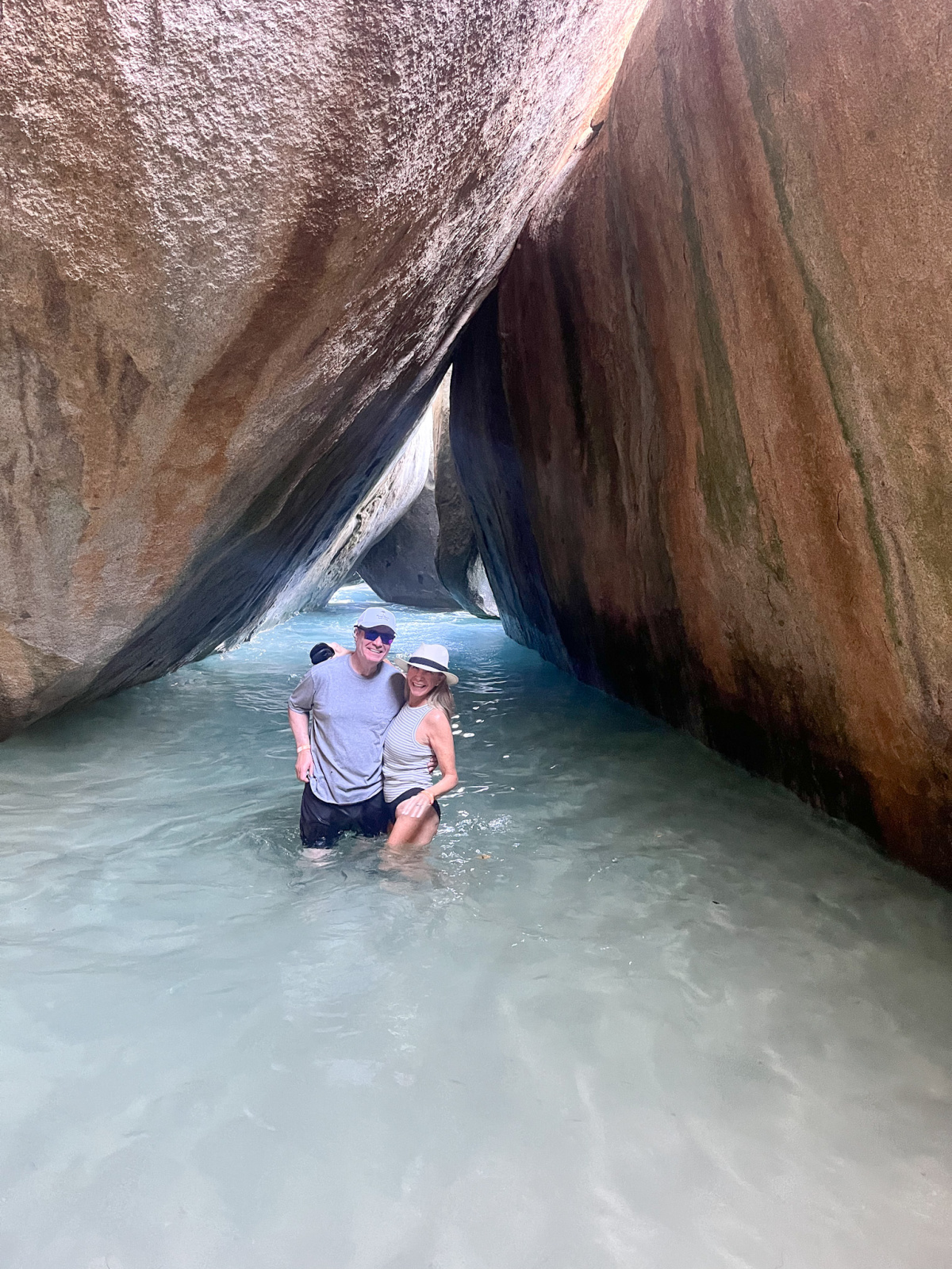Couple under caves at Virgin Gorda Baths.