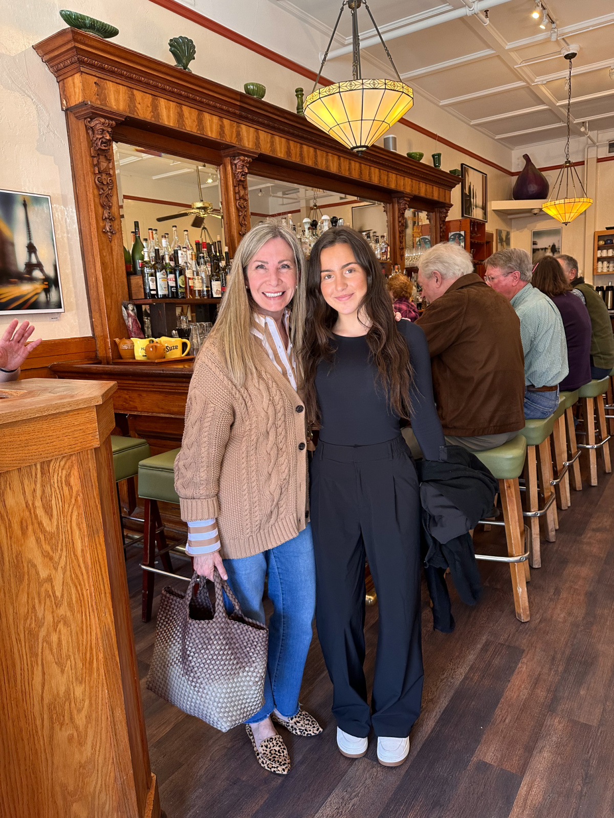 Woman standing in front of bar at Girl and the Fig.