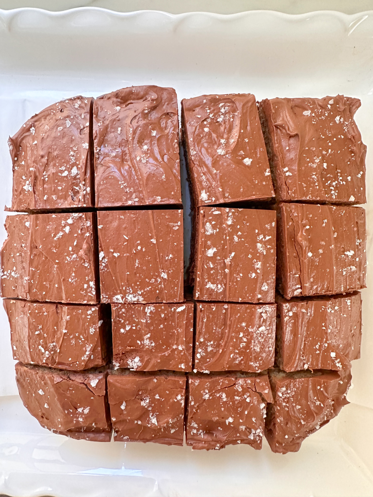 Sliced pieces of banana cake with chocolate frosting.