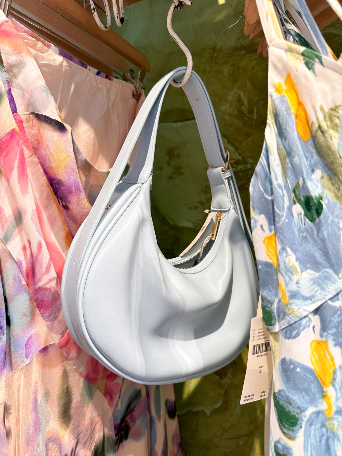 Pale blue shoulder bag on hanger at Anthropology.