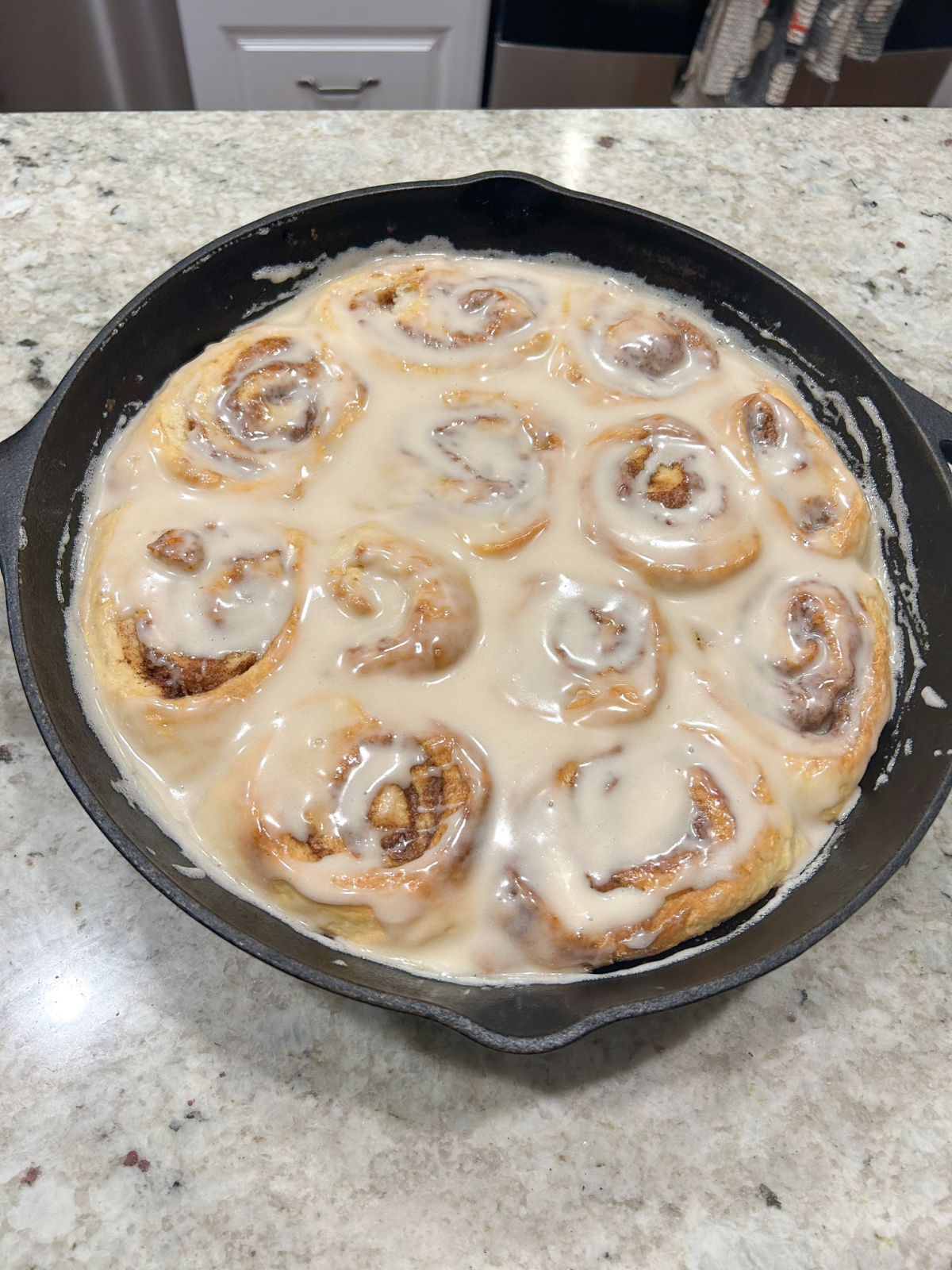 Sourdough cinnamon rolls in cast iron pan.