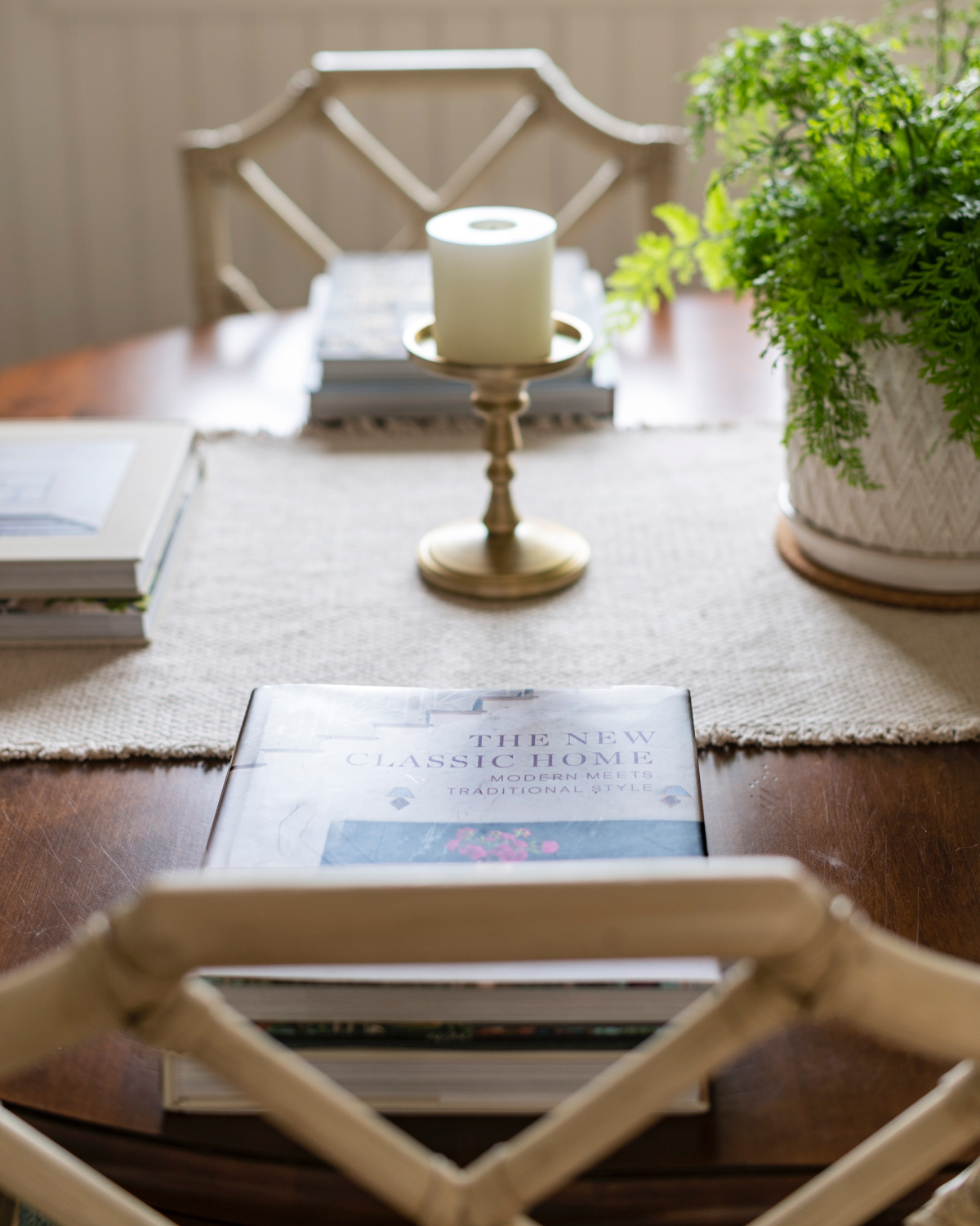 Dining table and chairs with place settings of books.