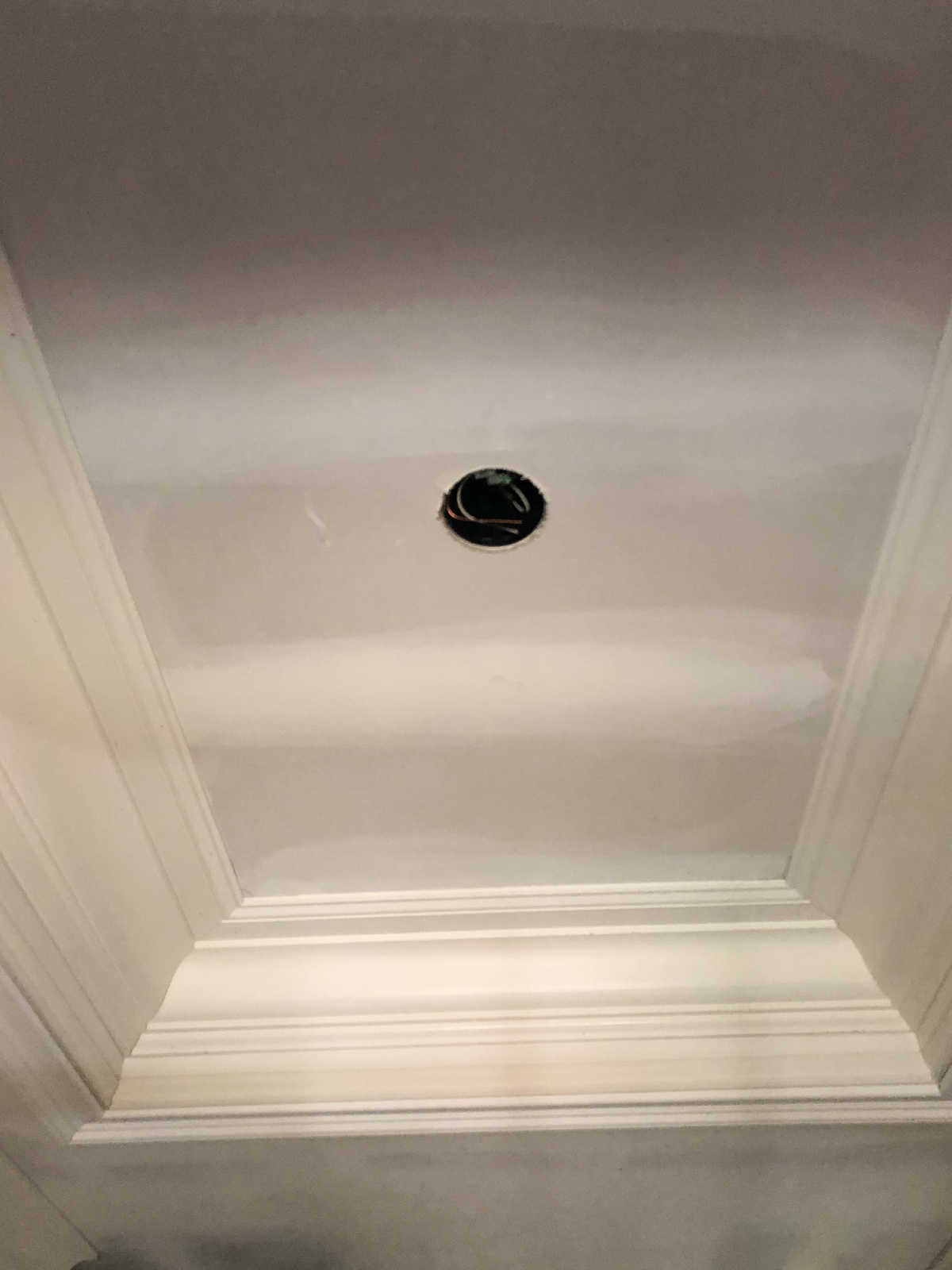 Ceiling in process of being frayed in small foyer.