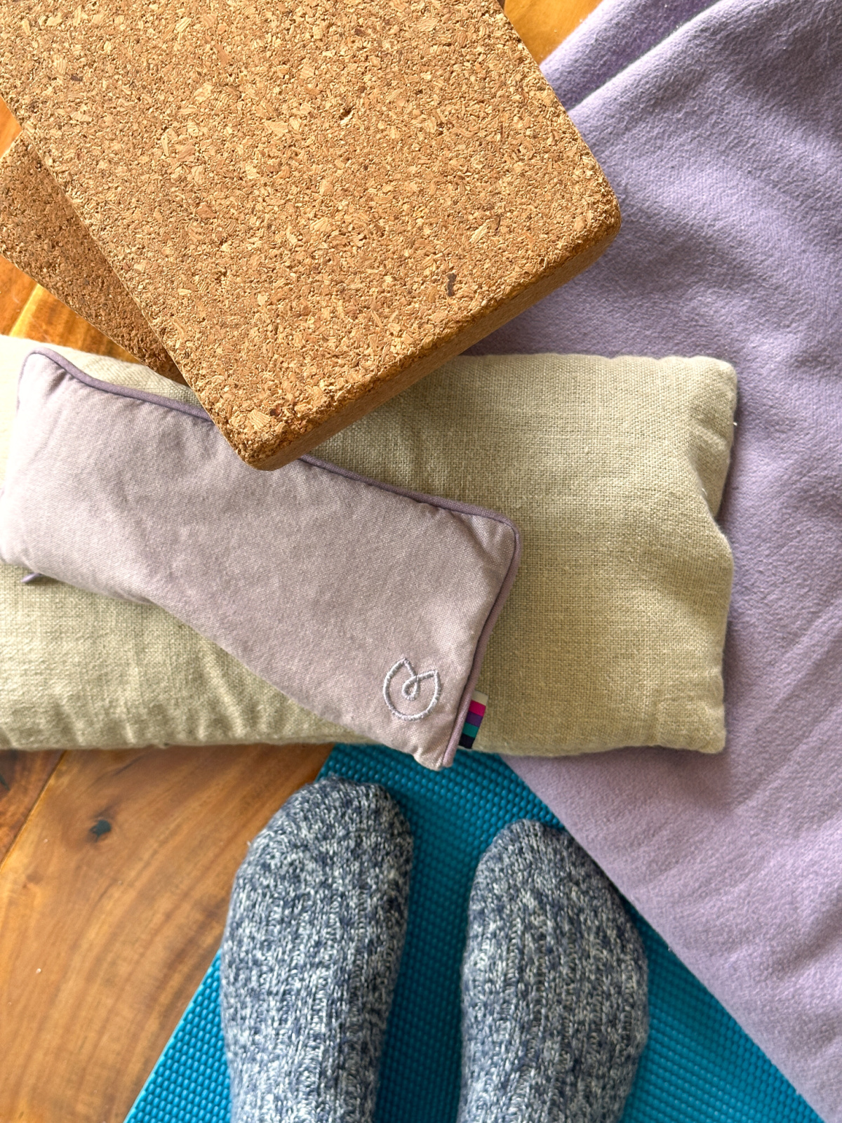 Overhead view of yoga props and yogi's socked feet.