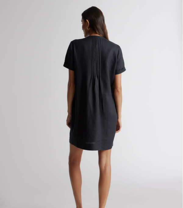 Model wearing Quince linen dress in black.