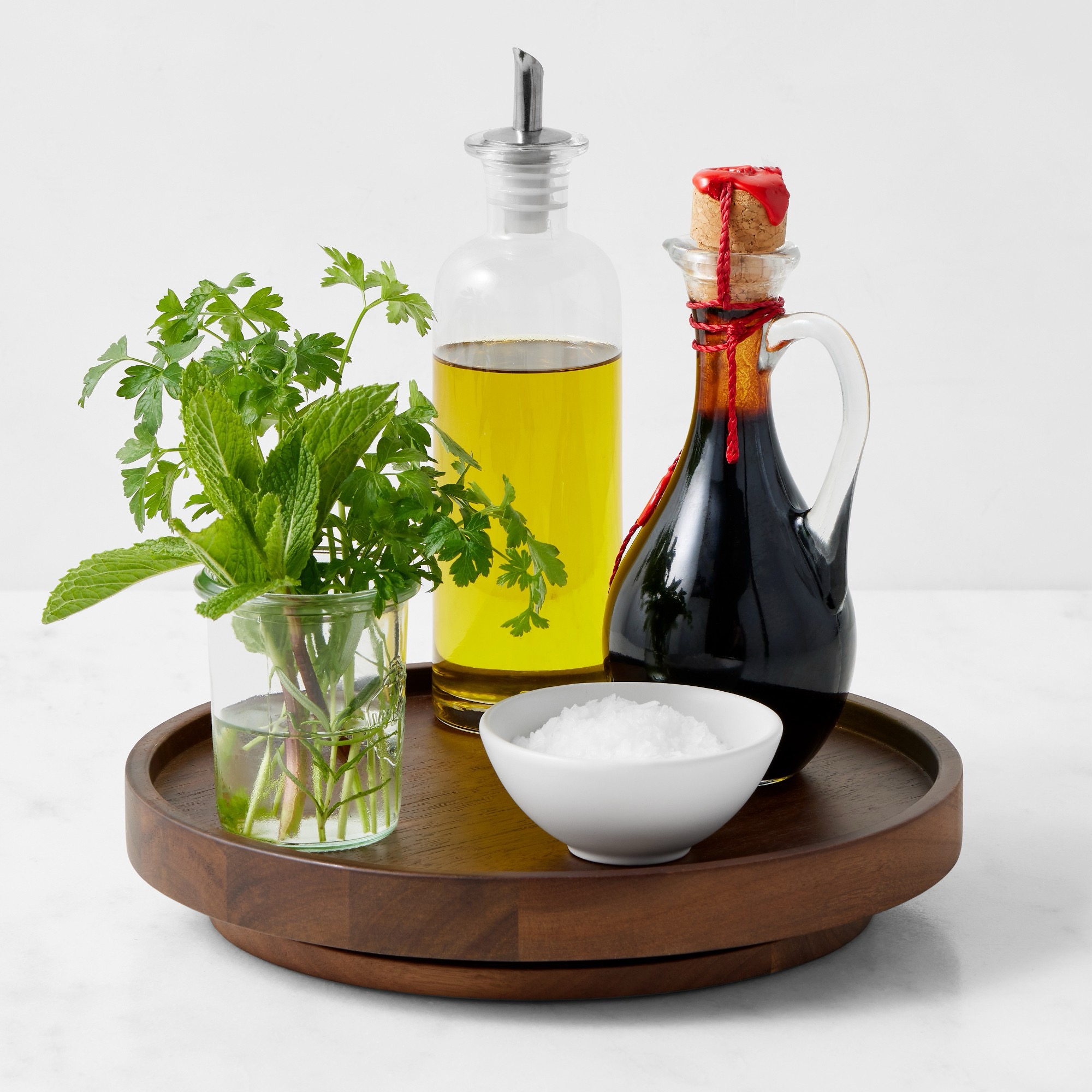 Walnut lazy Susan holding oil, vinegar, salt and herbs.