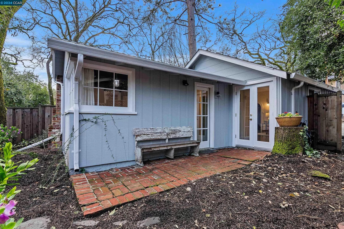 Tiny blue cottage from the back.