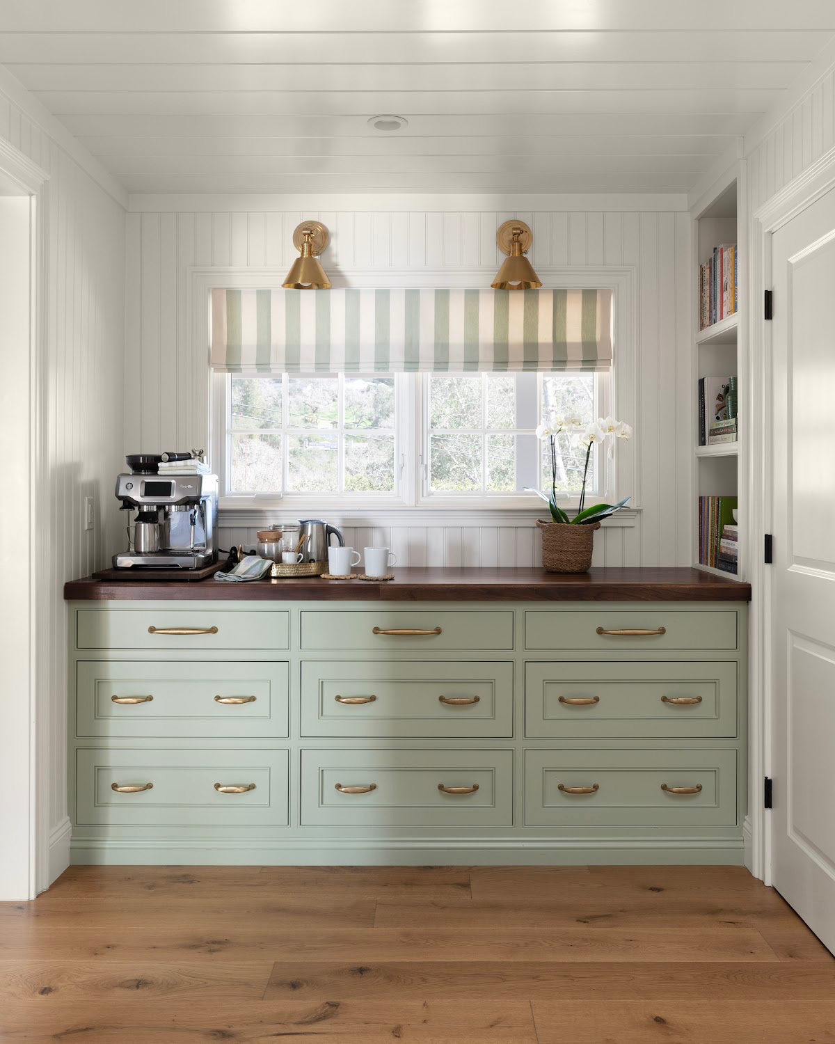 Kitchen built-in buffet with green cabinetry and walnut countertop and coffee bar set up.