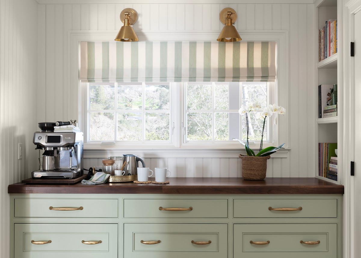 Kitchen built-in buffet under window with coffee bar set up.