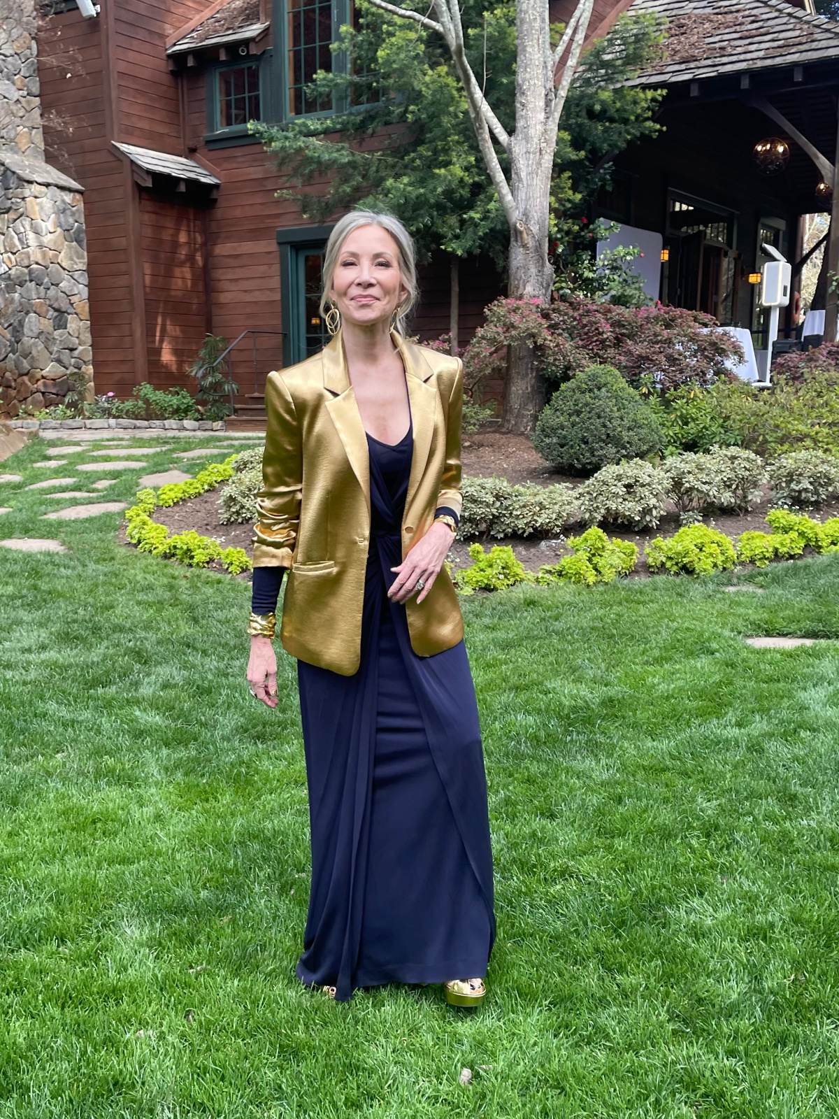 Woman wearing formal attire at outdoor wedding.