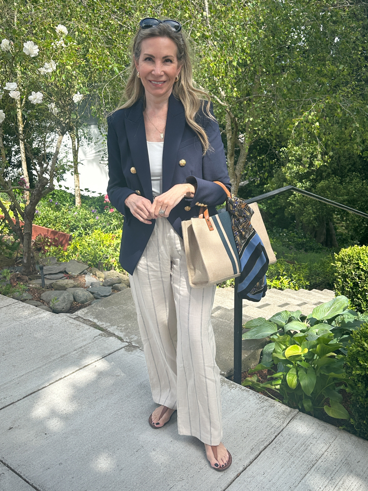 Woman wearing linen pants and blue blazer standing in Pacific Heights neighborhood of San Francisco.