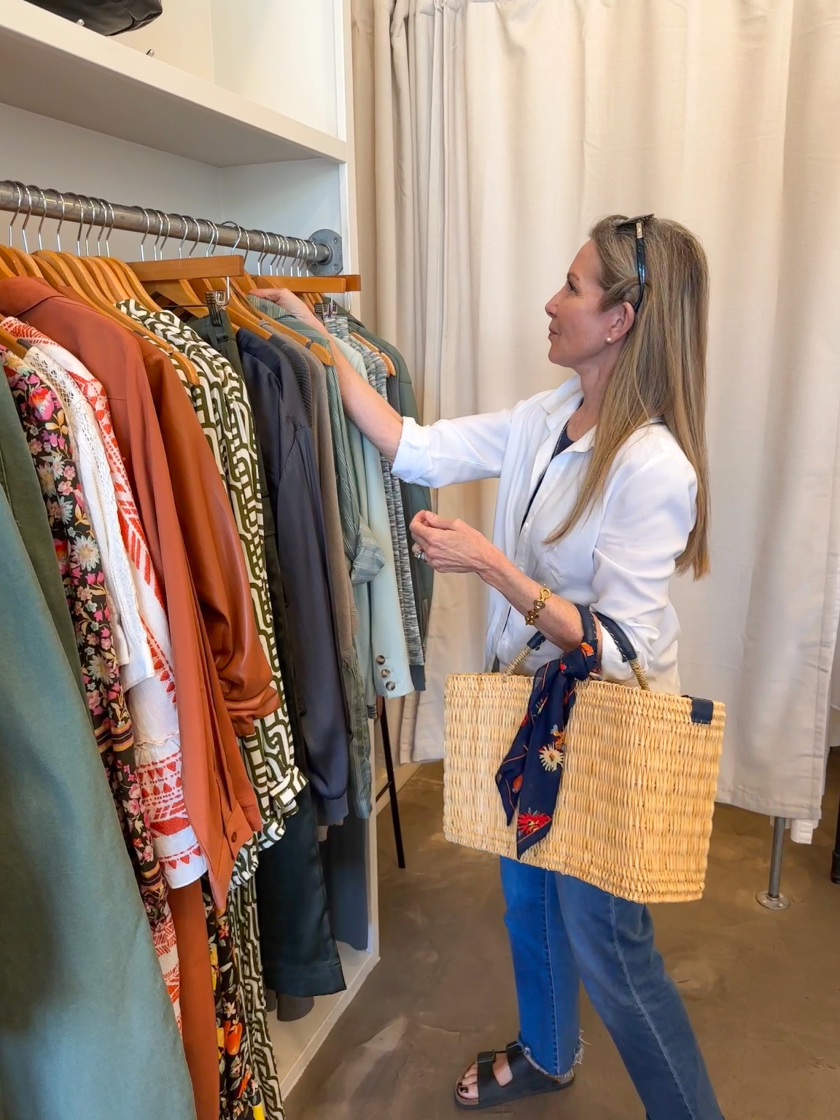 Woman looking at clothing racks at Rust at The Barlow.