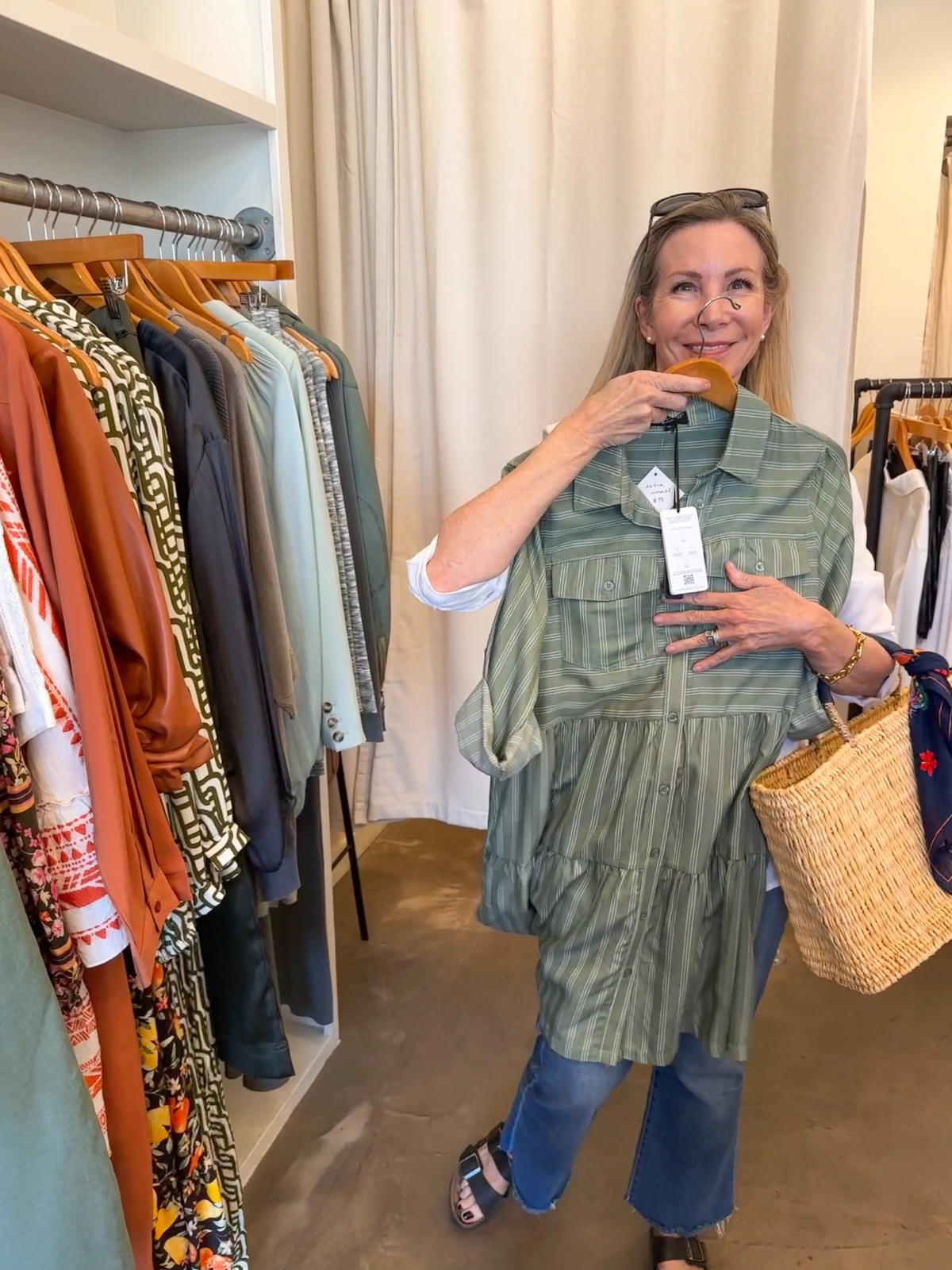 Woman holding up green dress at Rust.
