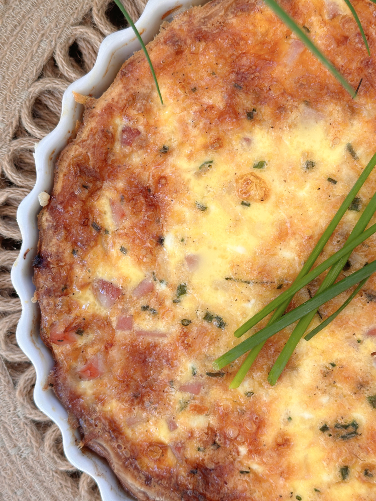 Overhead shot of Quiche Lorraine in white pie plate.