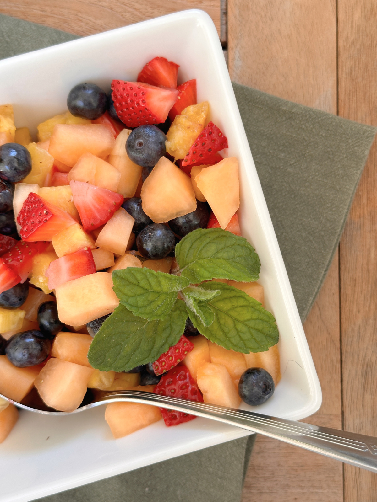 Overhead shot of fruit salad in square bowl.