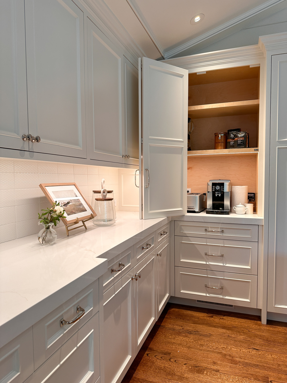 Shot of kitchen cabinet run ending with appliance garage.