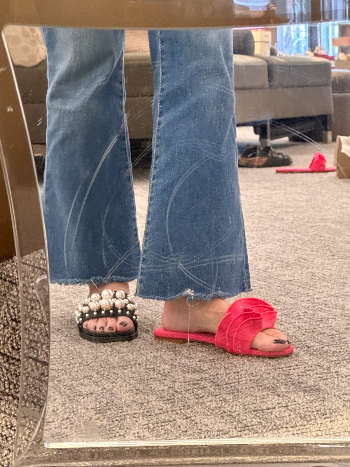 Woman trying on sandals at Nordstrom.