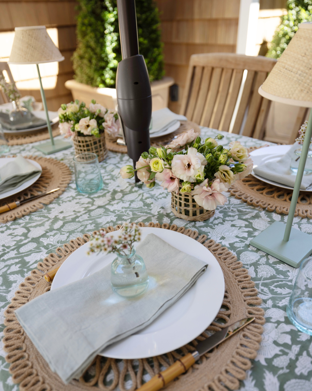 Close up of green and white outdoor table setting.