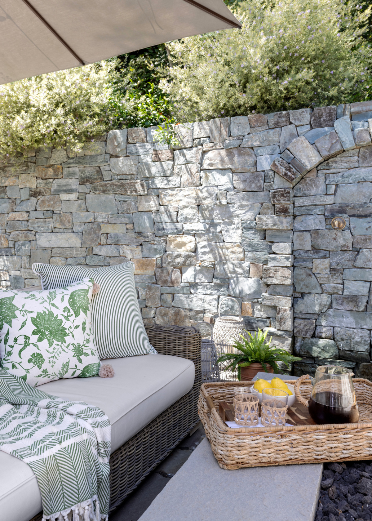 Patio seating area with pitcher of ice tea on tray.