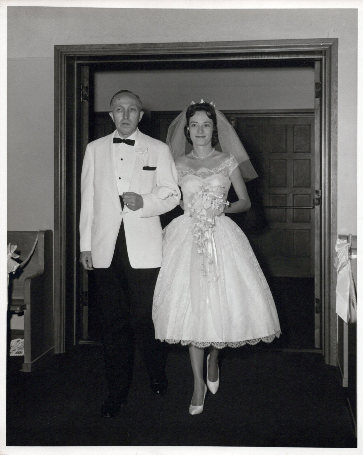Father walking his daughter down the aisle in 1960.