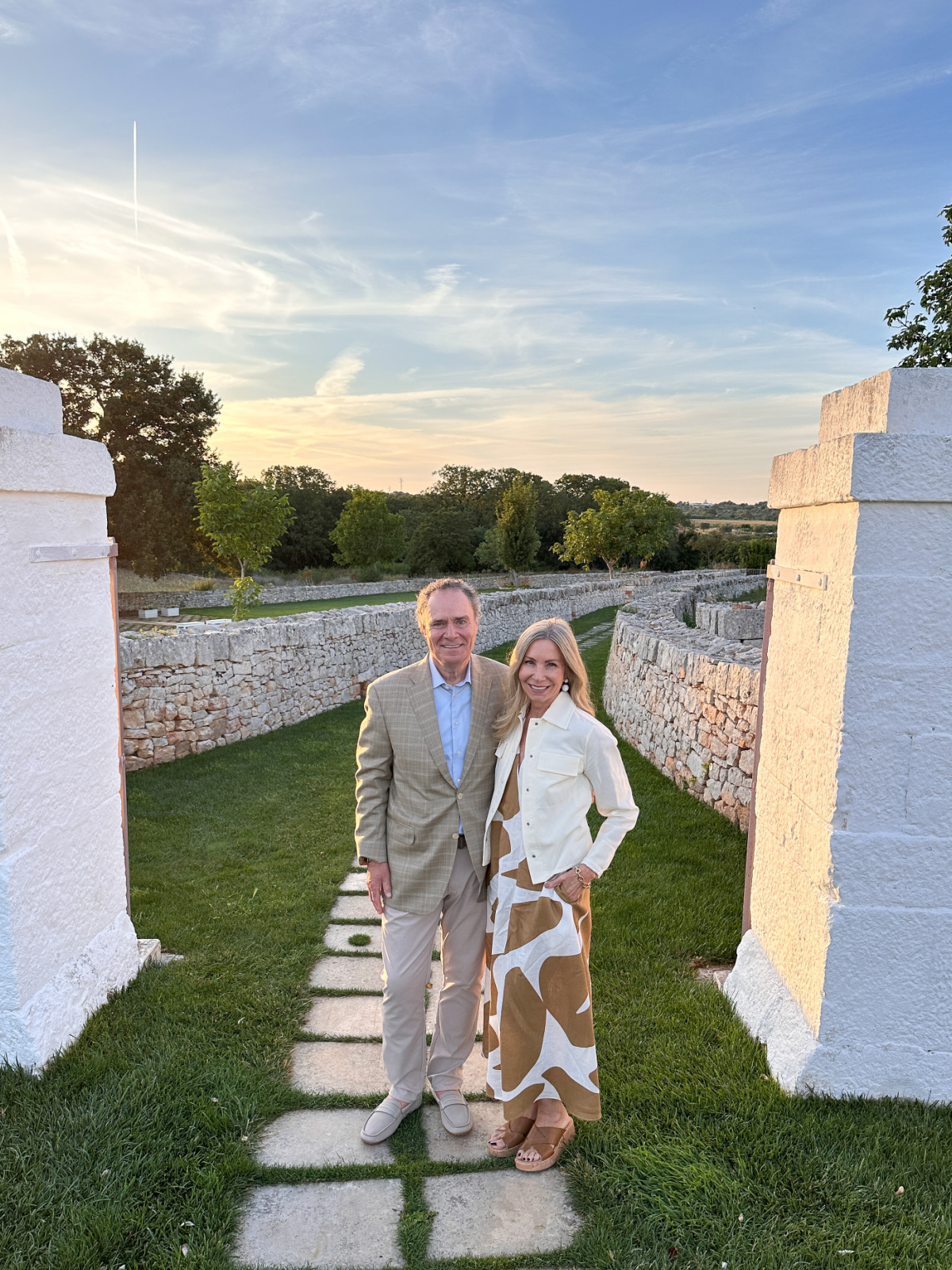 Couple standing in Italian garden.