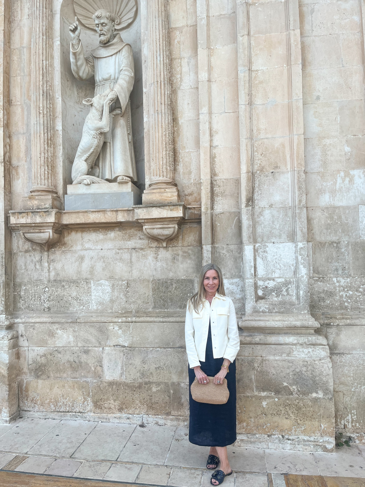 Woman standing in front of church in Italy.