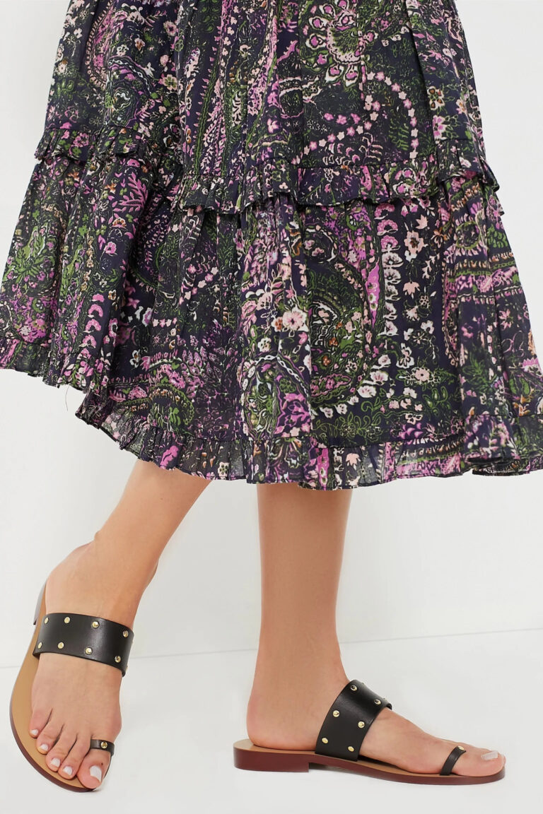 woman wearing floral peasant skirt and leather sandals.