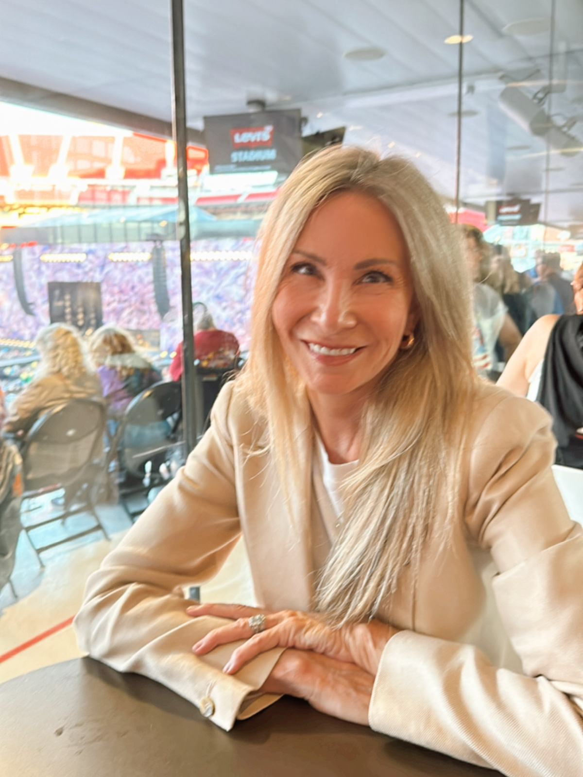 Woman sitting at table in United Club area at Levi Stadium.