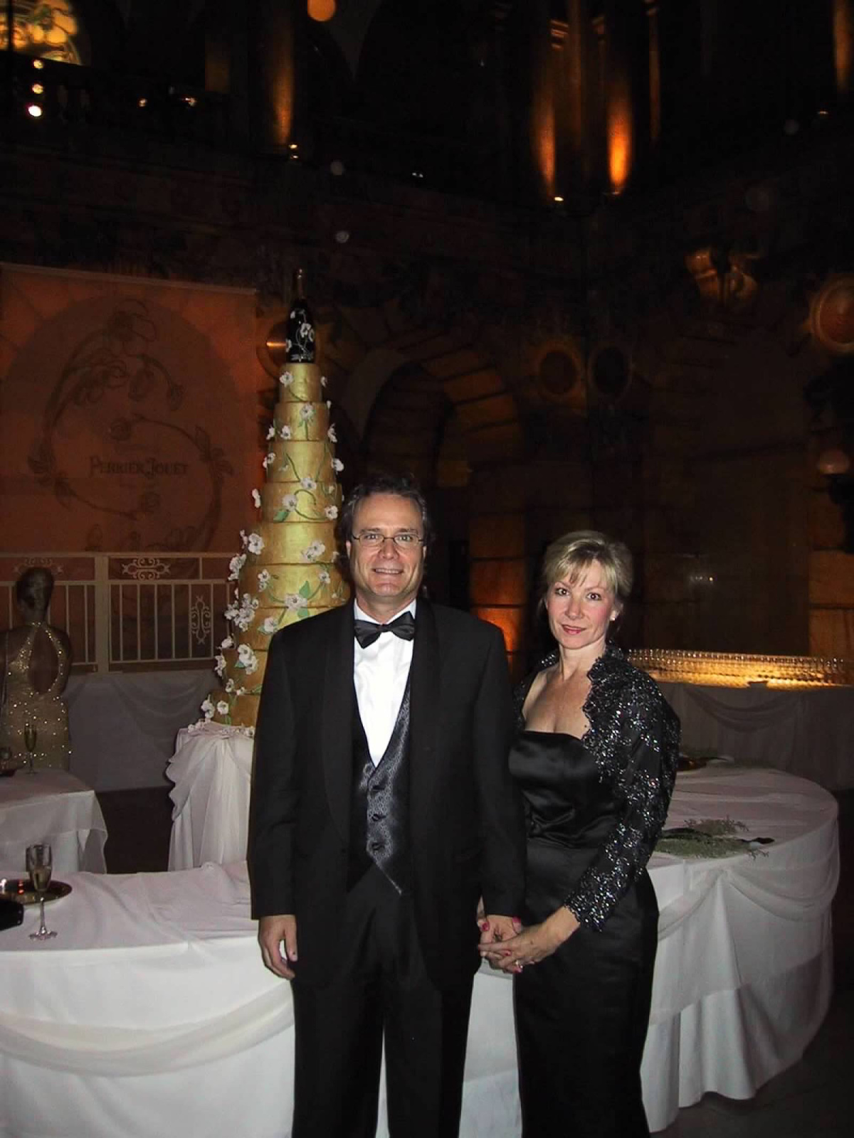 Couple dressed in black tie for Perriet Jouet event.