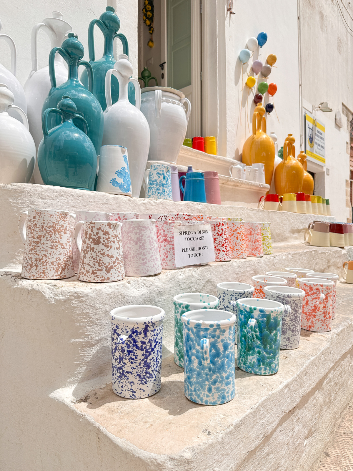 Speckled ceramic mugs for sale in Locorotondo, Italy.