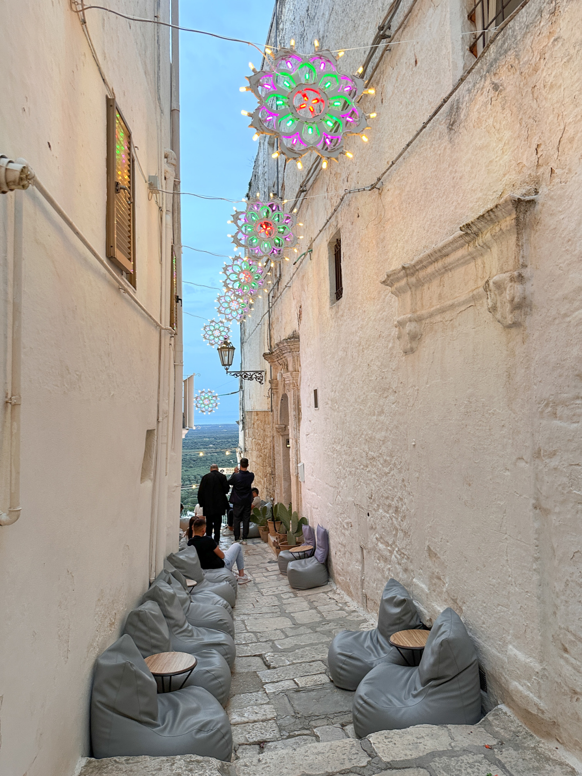 Alleyway with colorful lights in Ostuni.