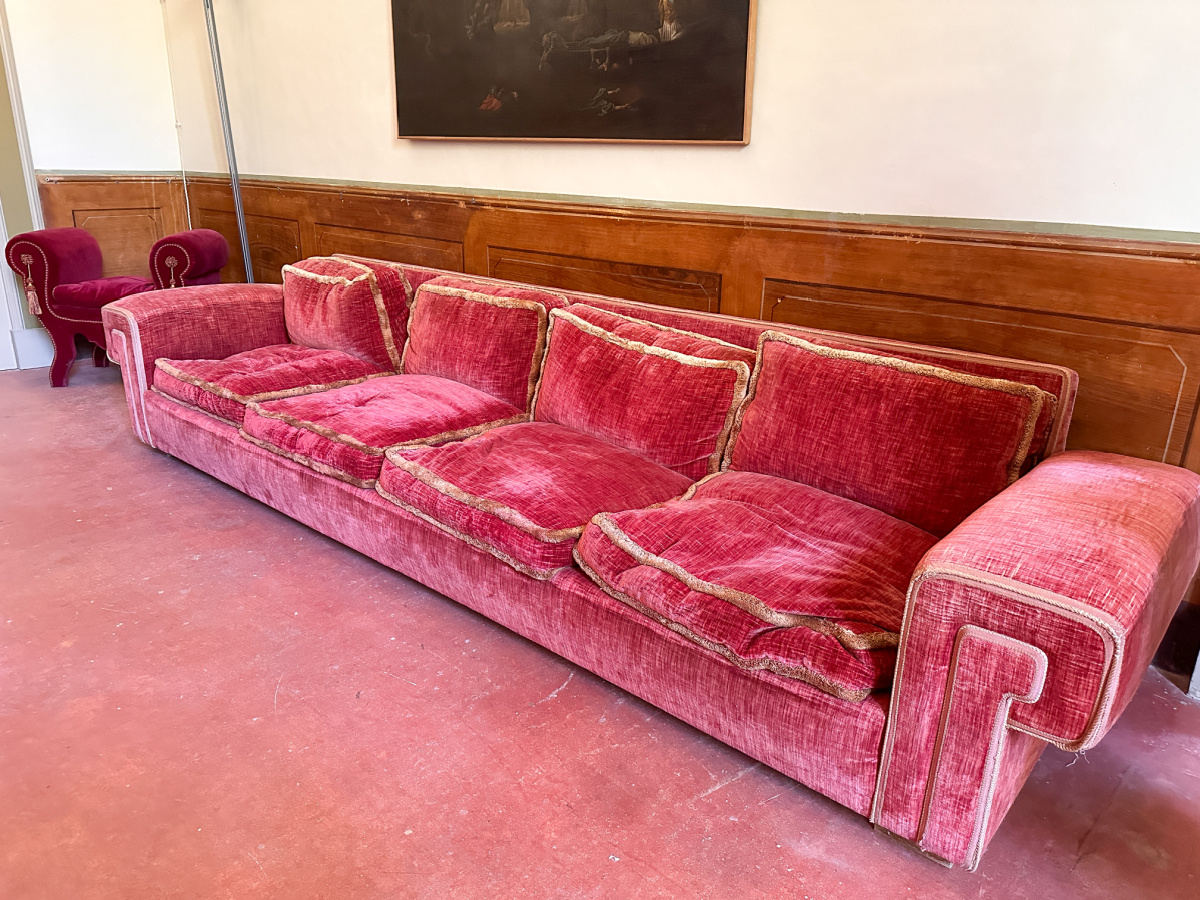 Red sofa in dining room of Palazzo Tamborino Cezzi.