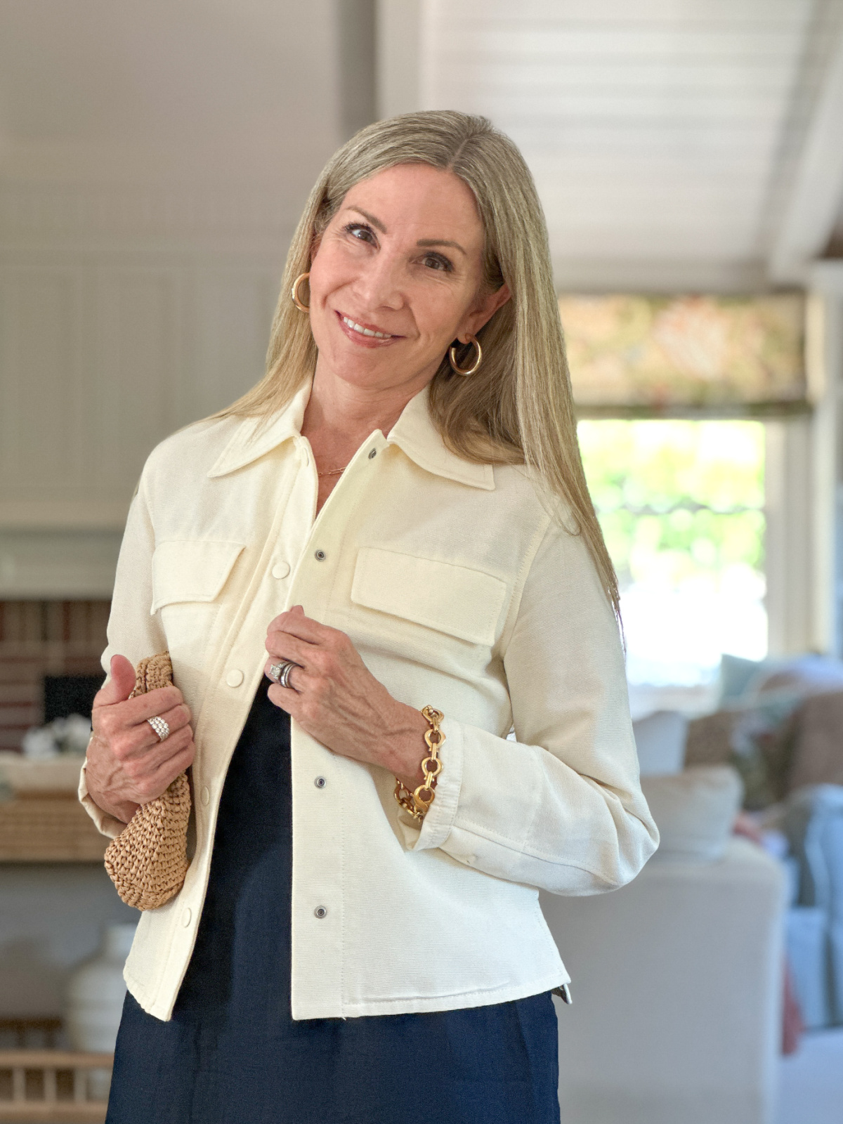 Woman wearing ivory cropped jacket by Vince.
