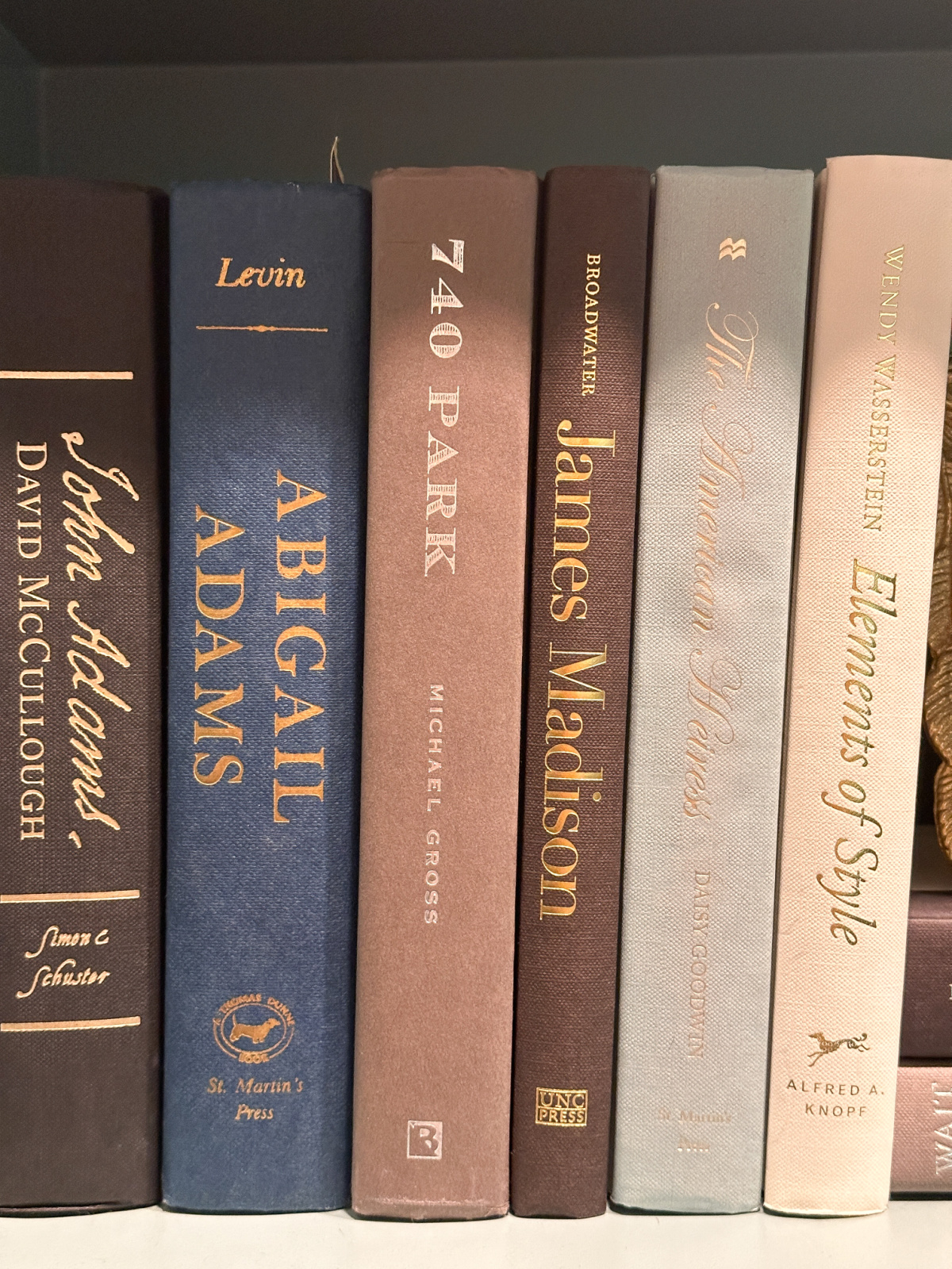 Photo of books on home library shelf.