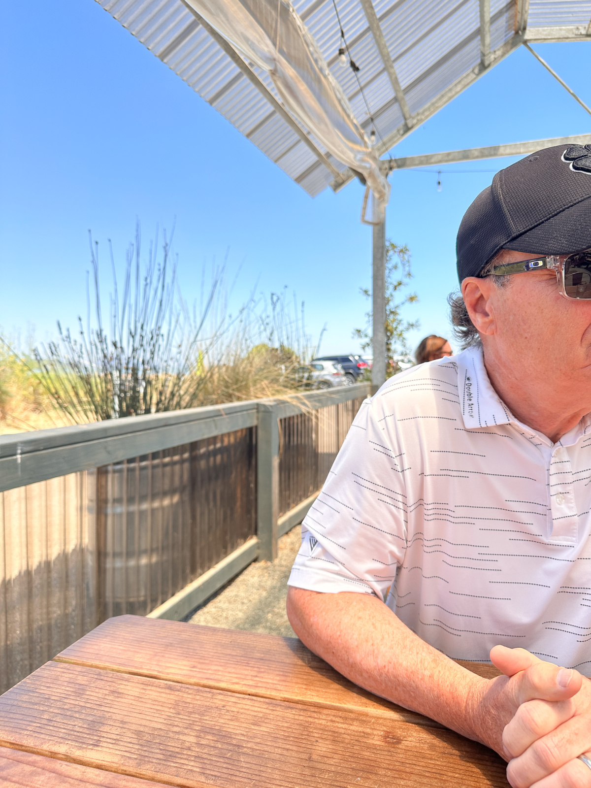 Man sitting at table on deck of Sailing Goat.