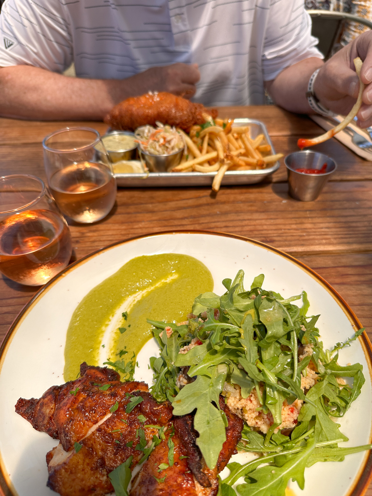 chicken and fish and chips plates on table at sailing goat.