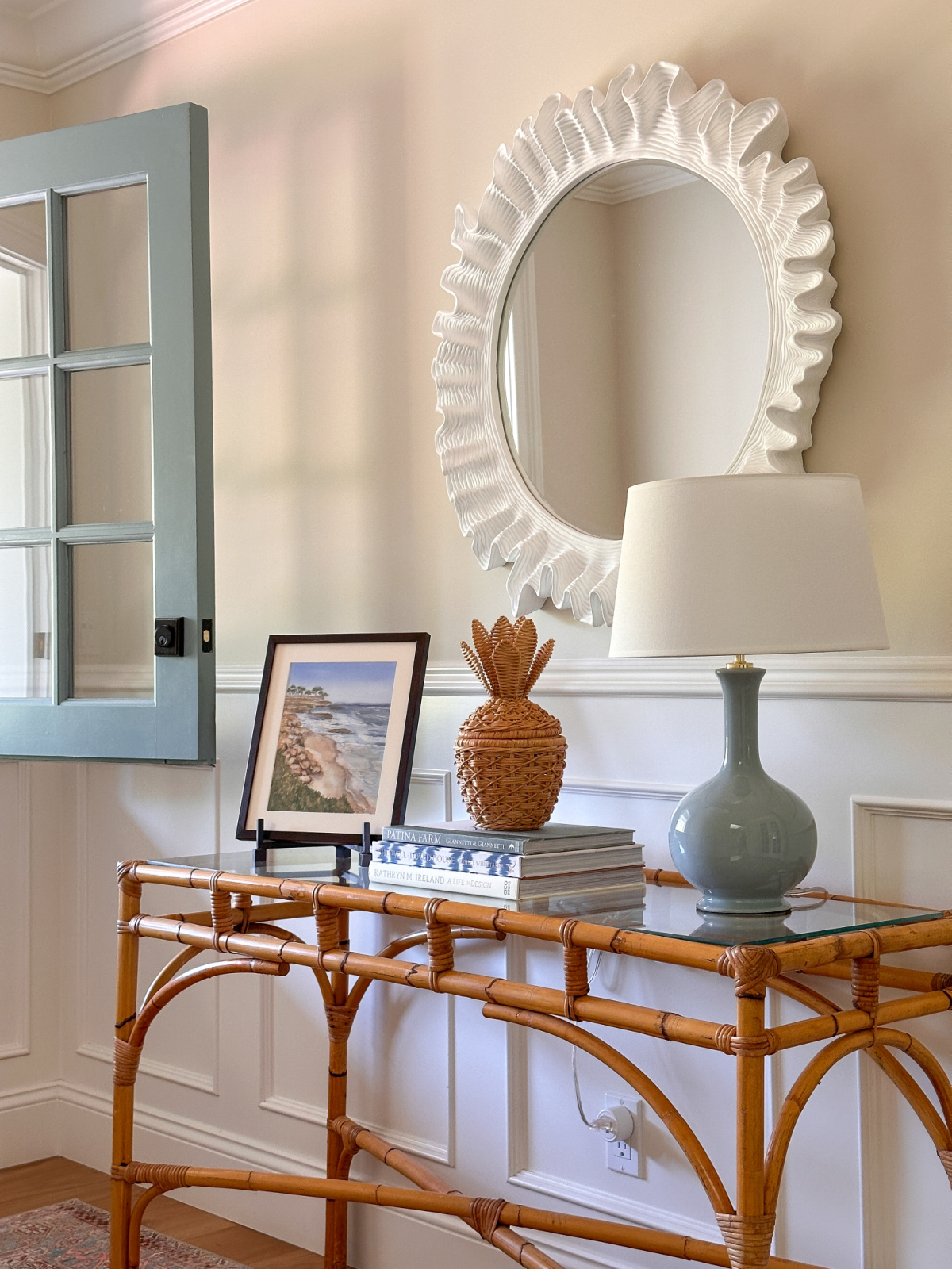 Foyer table with wicker pineapple.