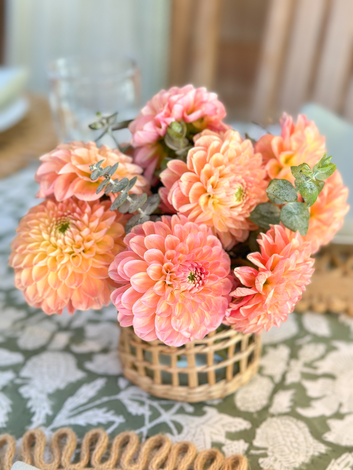 Small arrangement of coral dahlias.