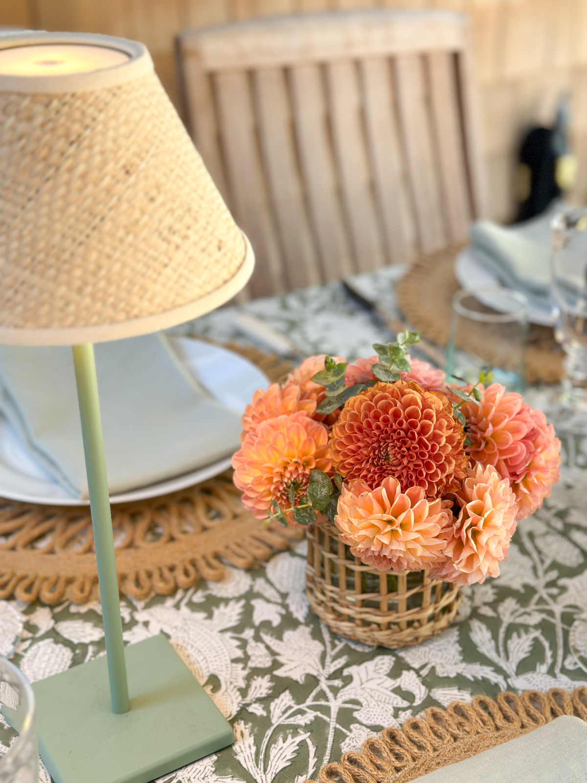Summer table setting with cordless lamps and coral dahlias.