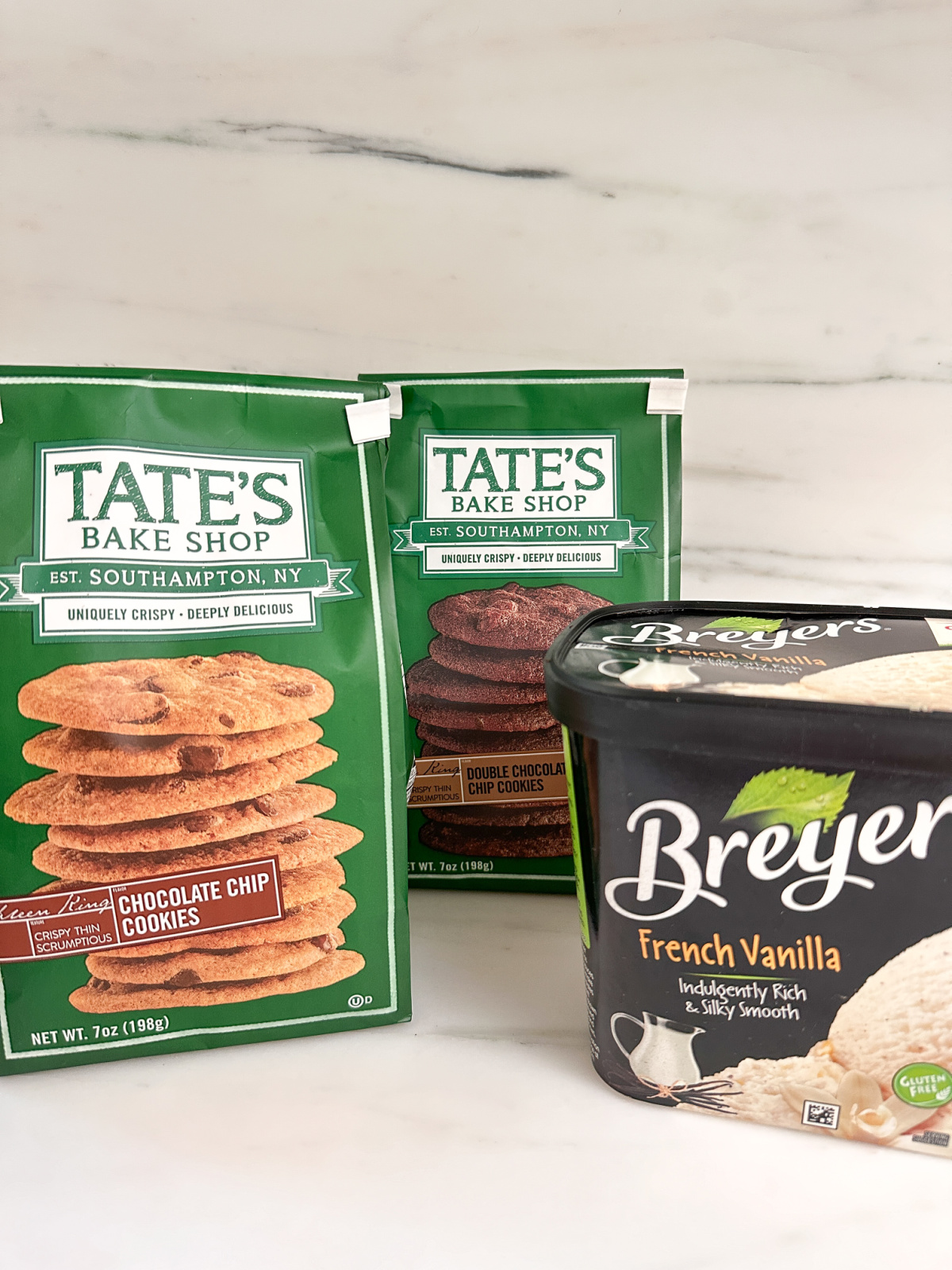 Bags of Tate's Bake Shop and a carton of Breyer's ice cream.