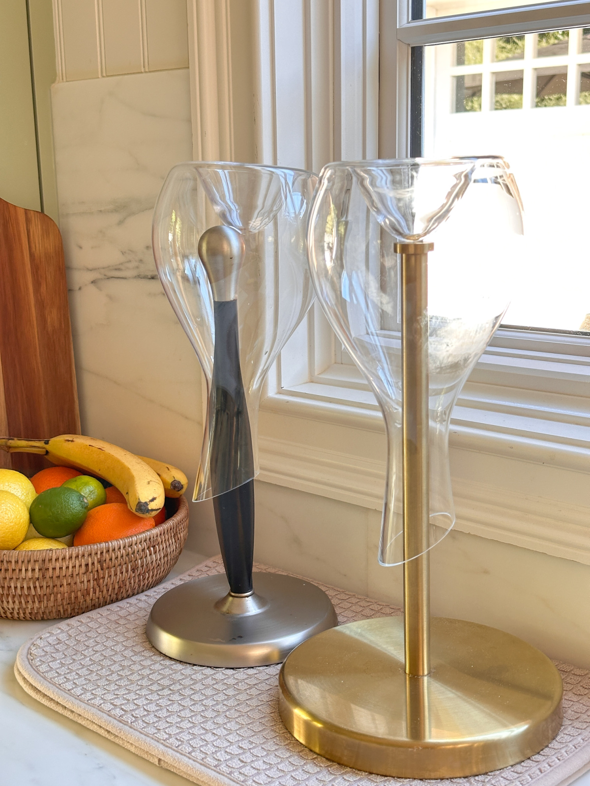 Wine decanters drying upside down on paper towel holders.