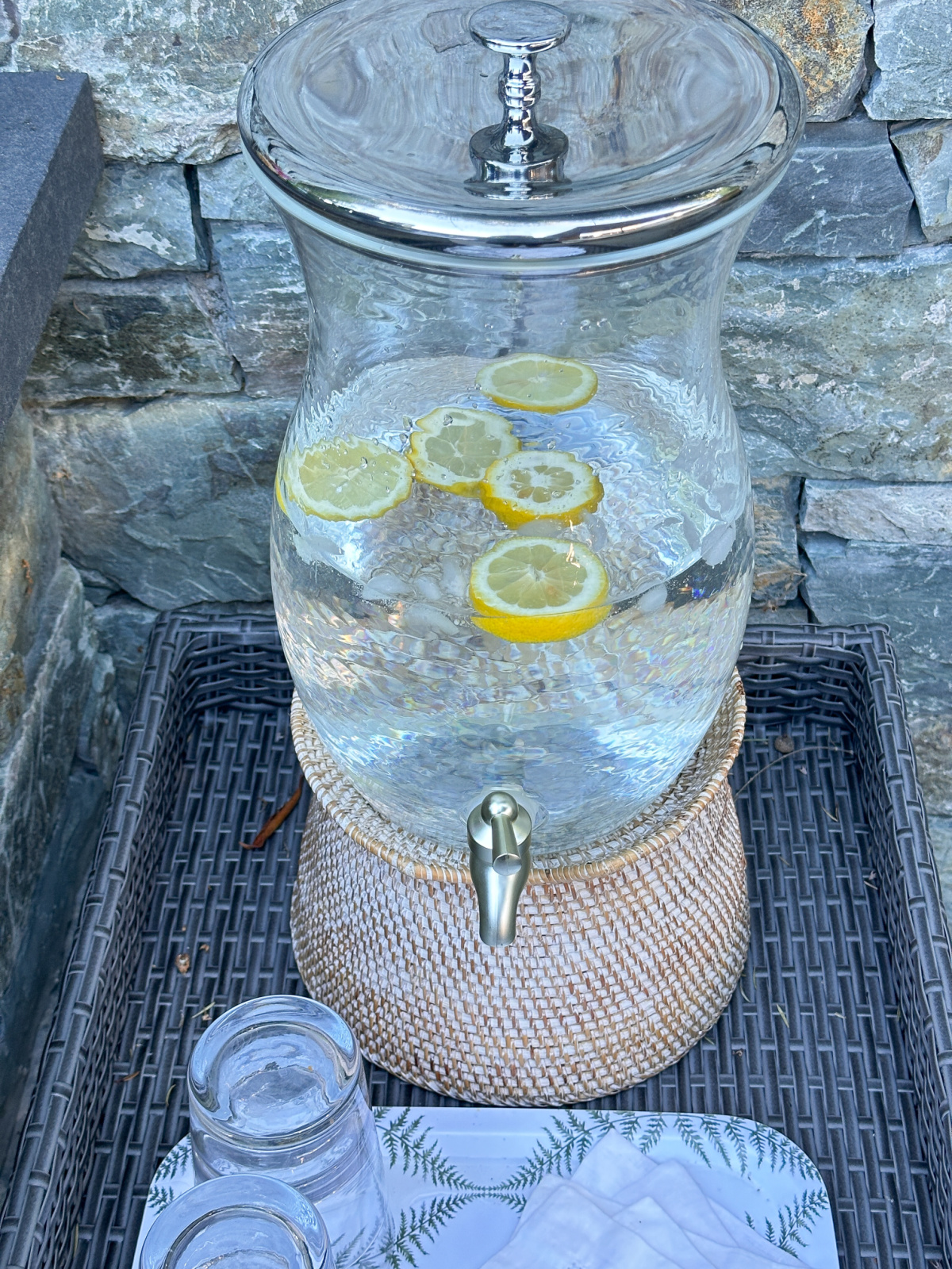 Water dispenser on woven tray.