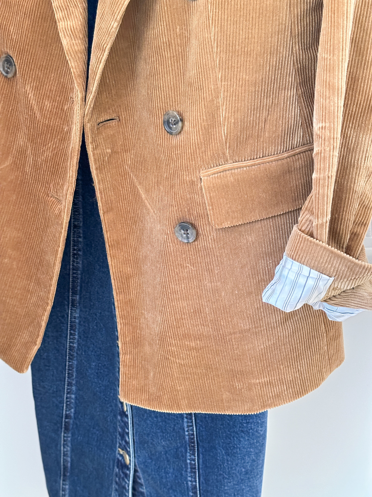 Brown corduroy blazer over denim dress.