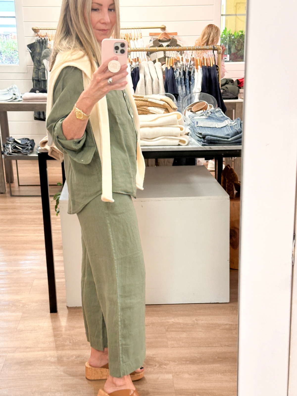 Woman wearing olive green linen set in Flaunt boutique.