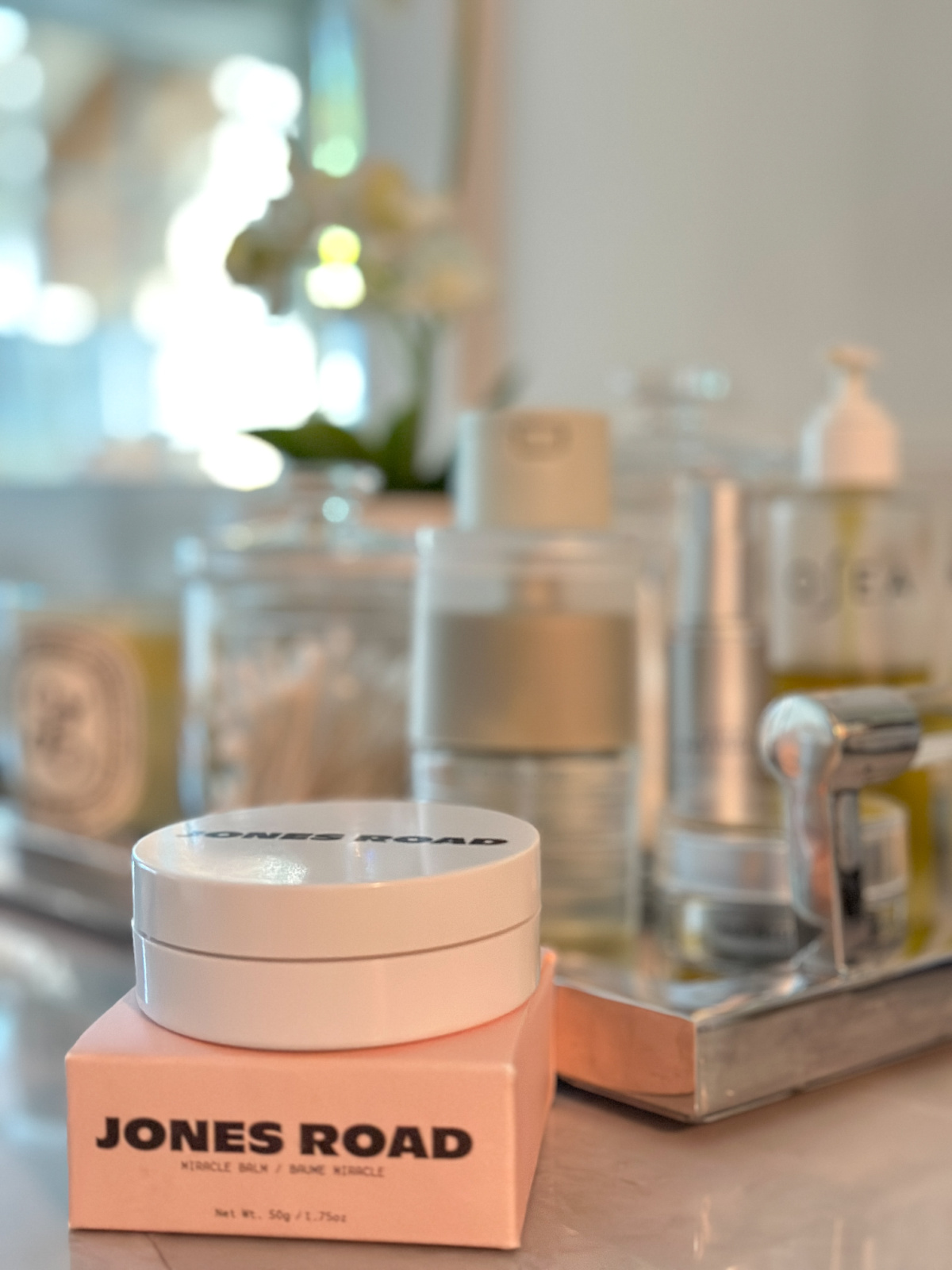 Jars of Jones Road Miracle Balm on bathroom vanity.