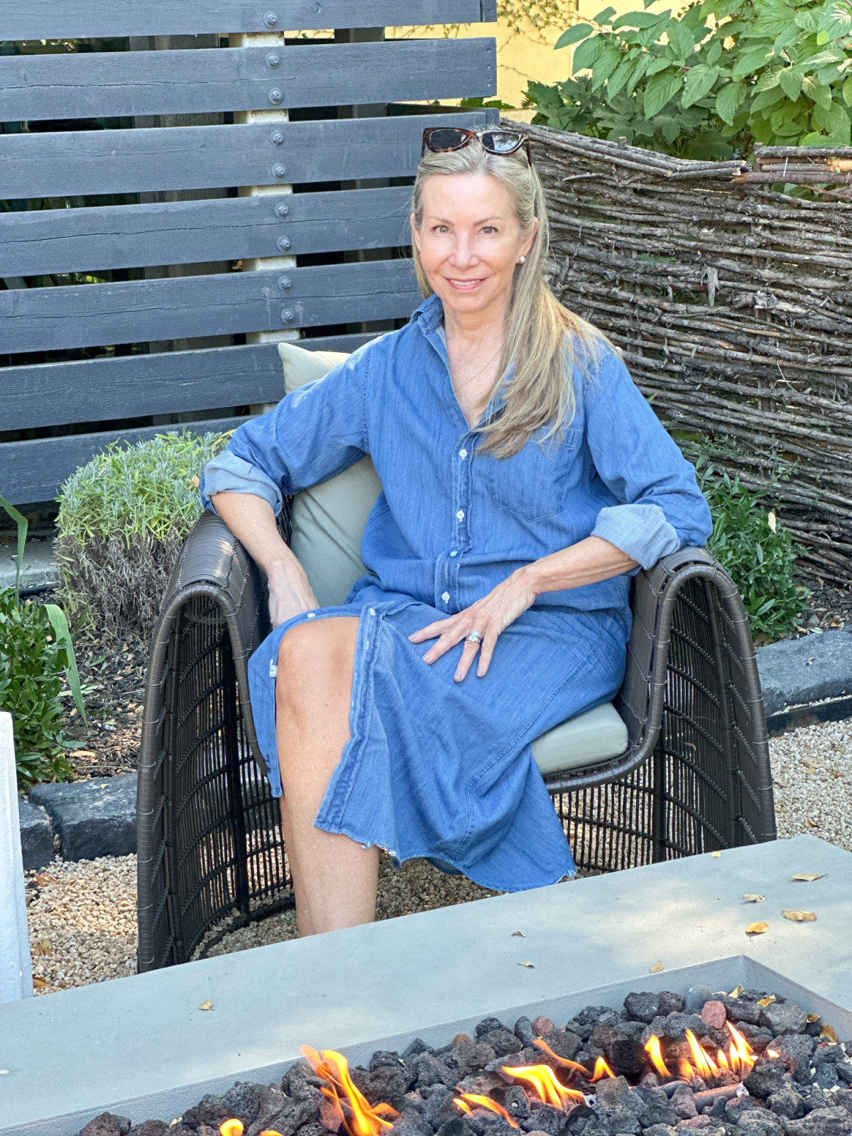 Woman sitting at fire pit at Hotel Healdsburg.