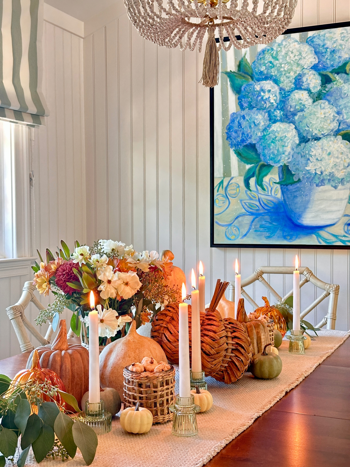 Fall table centerpiece with candles burning.