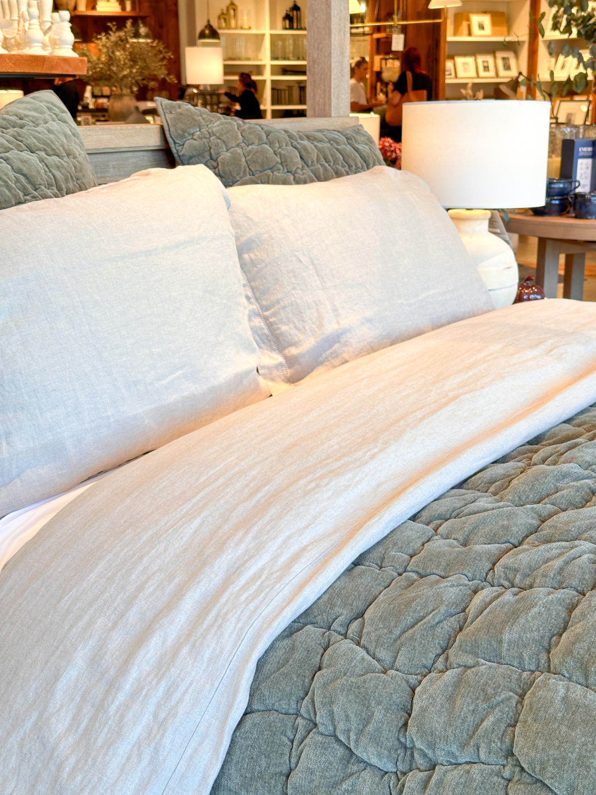 Green bedding at Pottery Barn store.