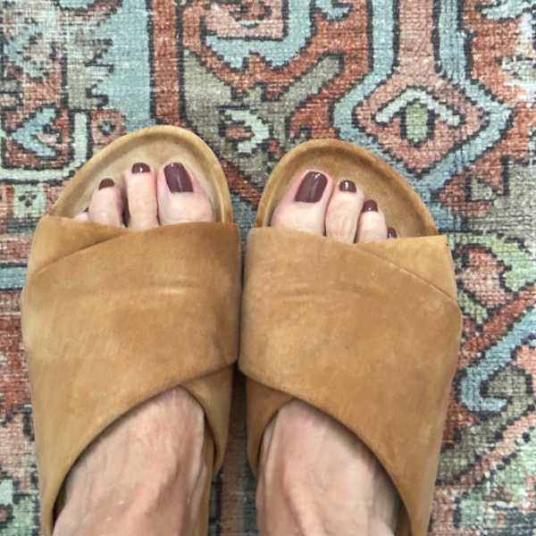 Woman wearing Beek sandals with Lingering Over Coffee polish on her toes.