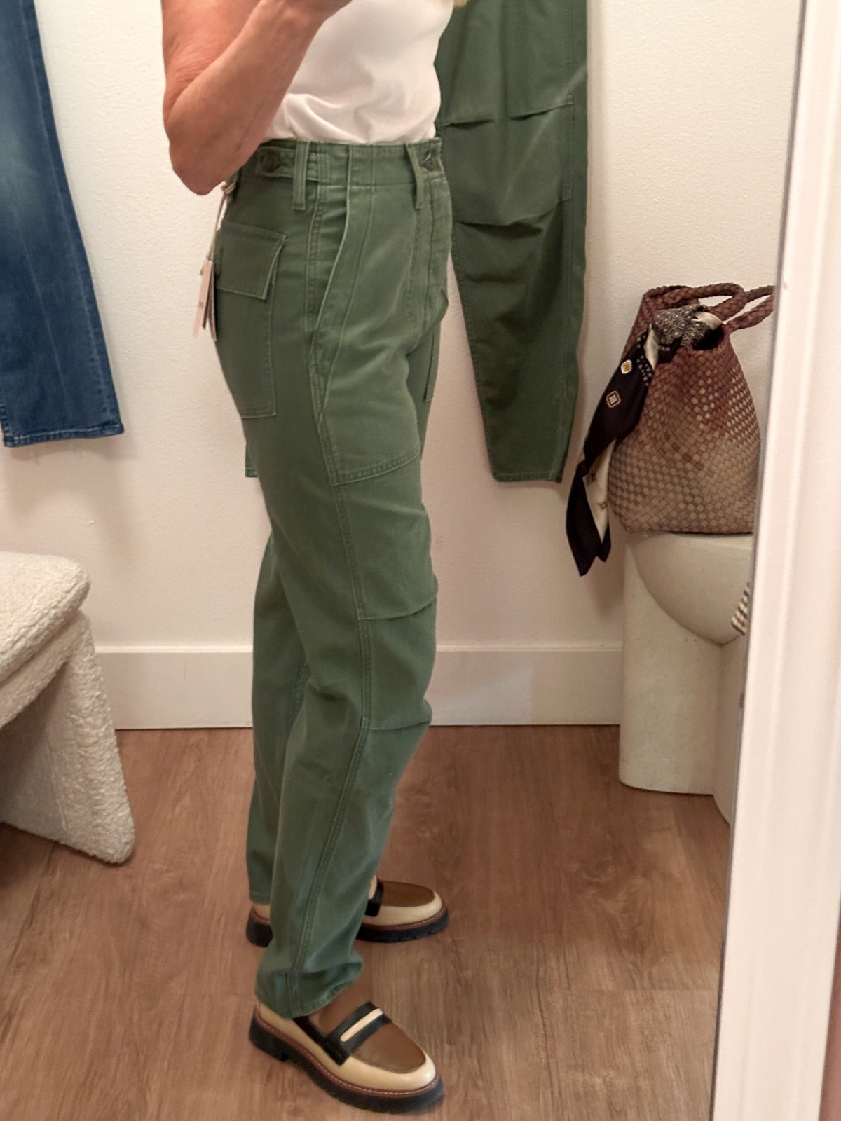 Woman wearing Mother Denim army green chinos.